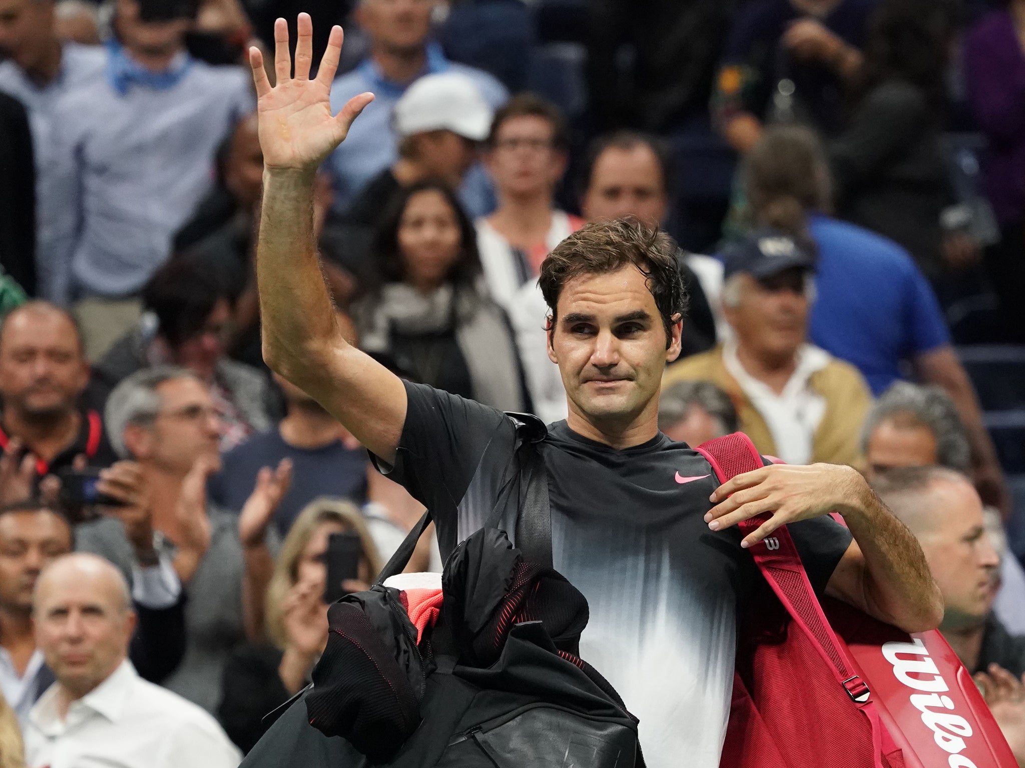 Federer waves to the crowd following his defeat by Del Potro