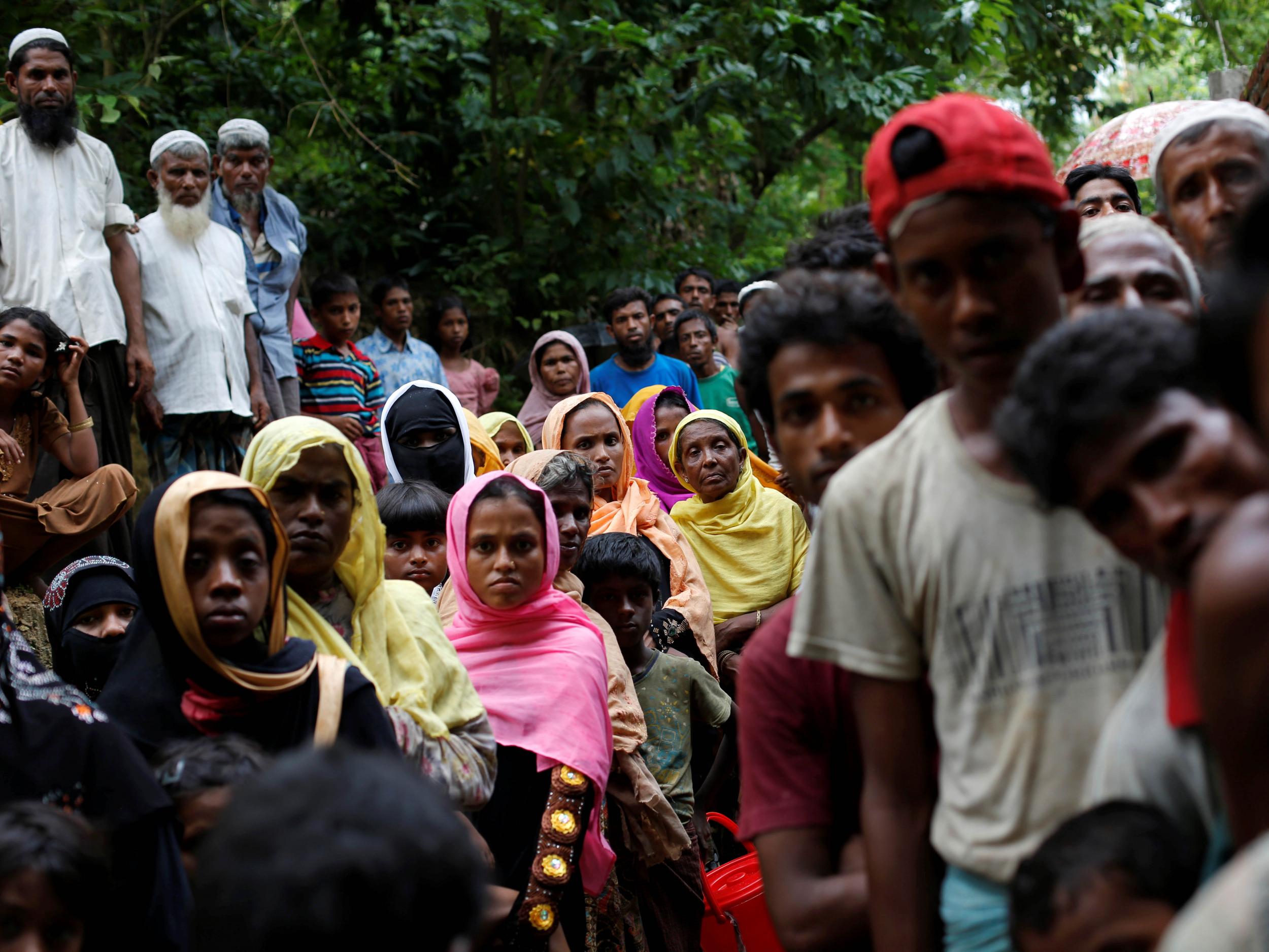 Rohingya refugees wait for food near Kutupalong refugee camp after crossing the Bangladesh-Burma border in Ukhia
