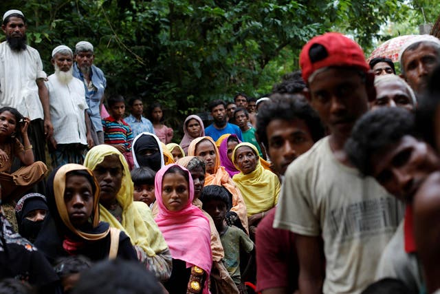 Rohingya refugees wait for food near Kutupalong refugee camp after crossing the Bangladesh-Burma border in Ukhia