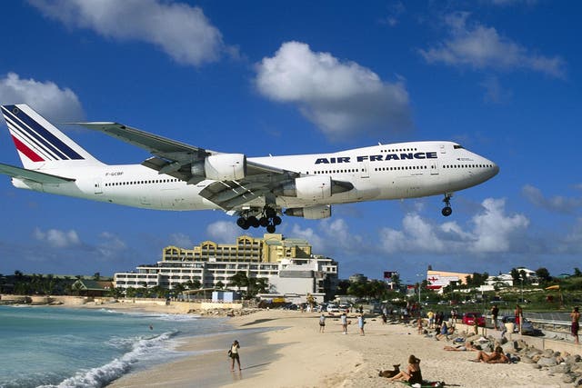 Princess Juliana International Airport is famed for planes flying over beach-goers' heads as plane spotters cling to fences to feel the jet blast of aircraft taking off