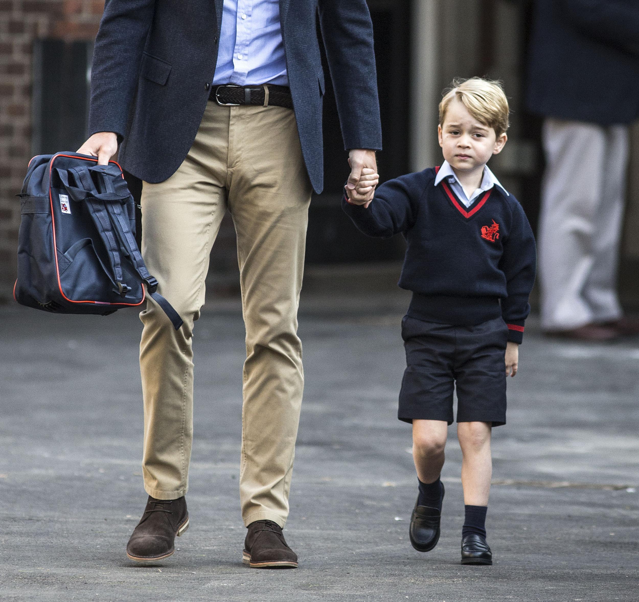 Prince George arriving for his first day at Battersea school, accompanied by his father