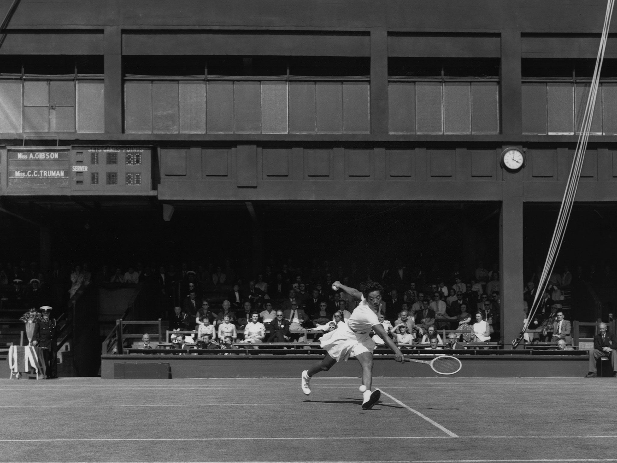 Gibson in action against Christine Truman during the 1958 Wightman Cup at Wimbledon