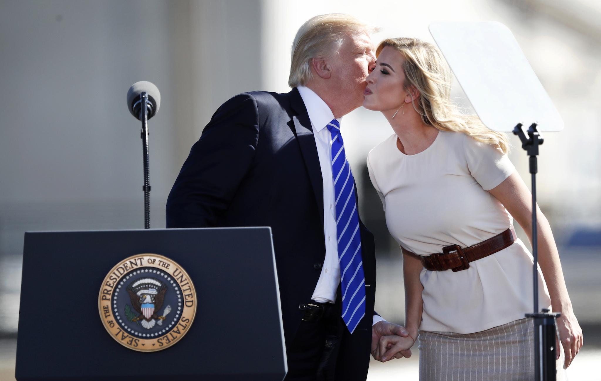 President Donald Trump kisses his daughter Ivanka, right, before speaking about tax reform