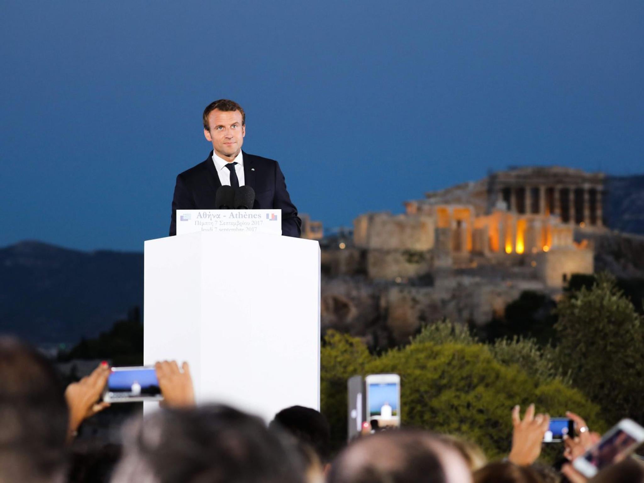 French President Emmanuel Macron reacts after delivering a speech on the Pnyx hill in Athens