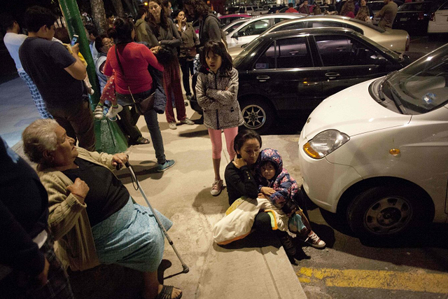 People react on a street in downtown Mexico City during an earthquake on September 7, 2017.
An earthquake of magnitude 8.0 struck southern Mexico late Thursday and was felt as far away as Mexico City, the US Geological Survey said, issuing a tsunami warning. It hit offshore 120 kilometers (75 miles) southwest of the town of Tres Picos in the state of Chiapas. 
 / AFP PHOTO / PEDRO PARDOPEDRO PARDO/AFP/Getty Images