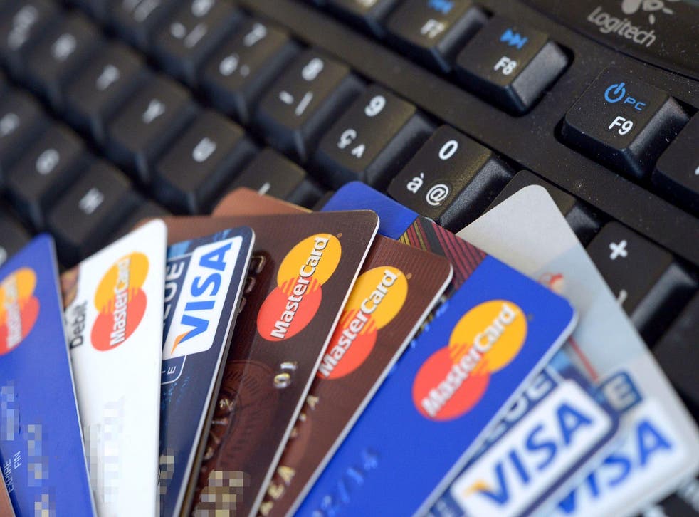 Credit cards are pictured on a computer's keyboard on February 5, 2013  in Rennes, western France