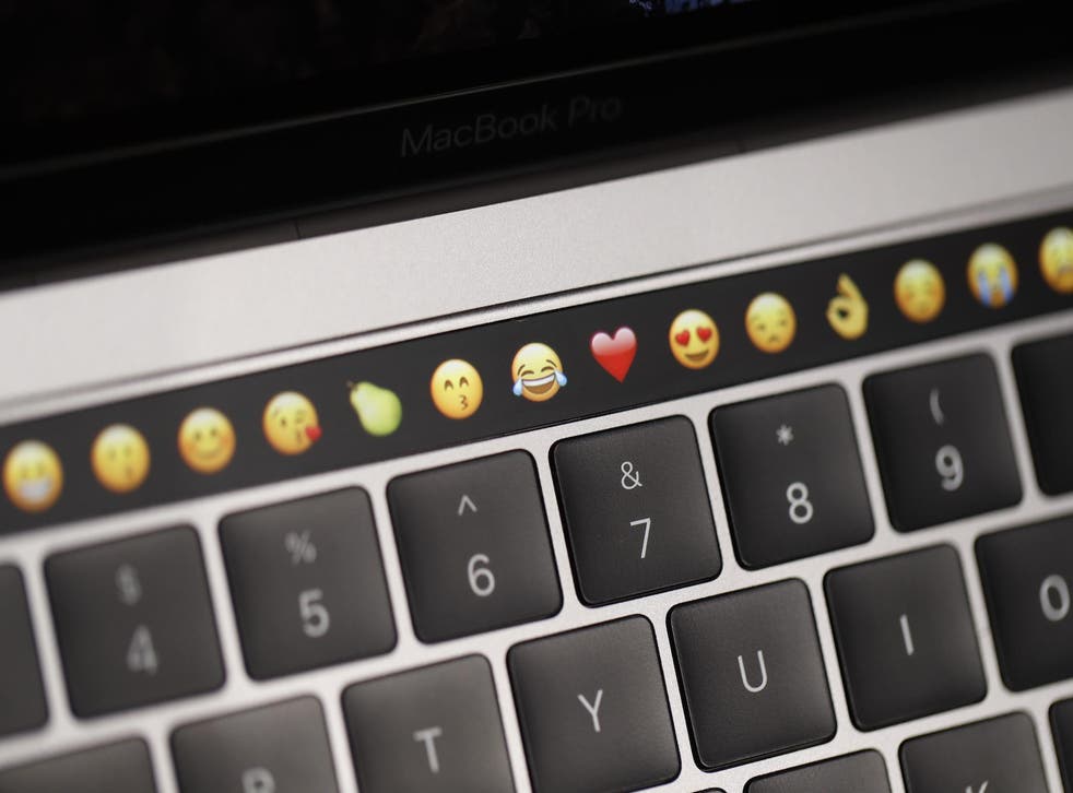 Emoticons are displayed on the Touch Bar on a new Apple MacBook Pro laptop during a product launch event on October 27, 2016 in Cupertino, California