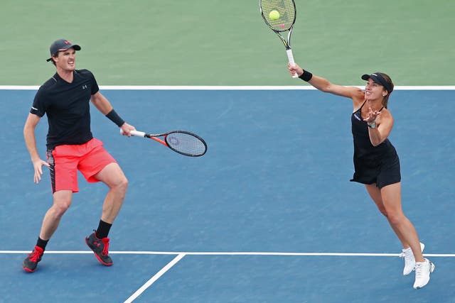 Martina Hingis, right, returns a shot as partner Jamie Murray watches on during their US Open semi-final win