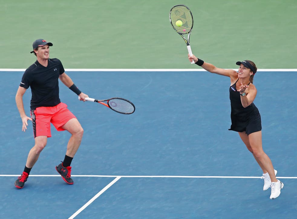 Martina Hingis, right, returns a shot as partner Jamie Murray watches on during their US Open semi-final win