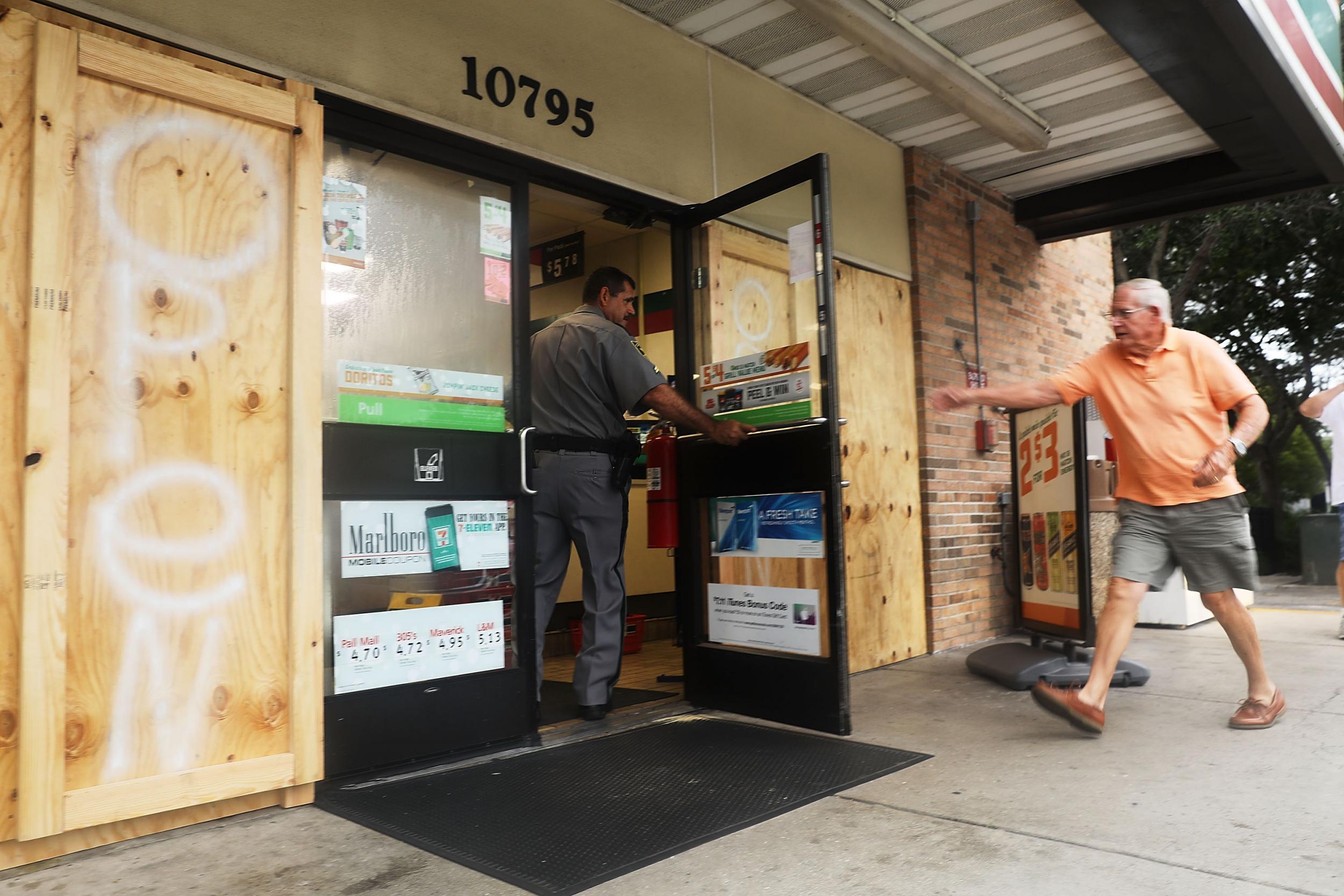 A man enters one the few remaining businesses open in Naples, Florida