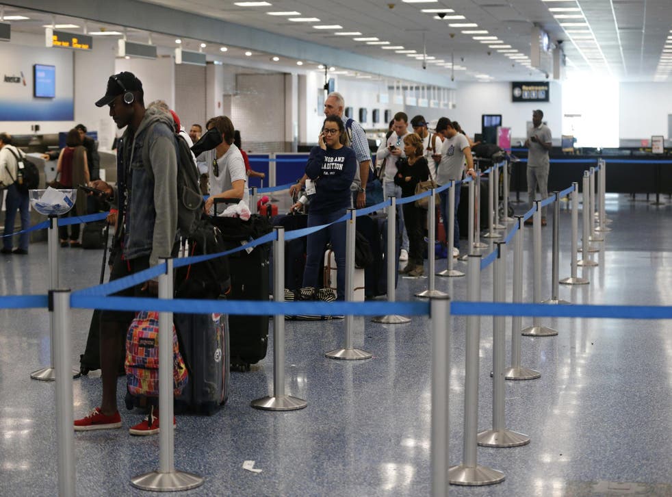 Passengers line up at the American Airlines counter at Miami International Airport