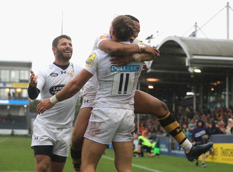 Josh Bassett celebrates with fellow try scorers Marcus Watson and Wilie le Roux after going over for Wasps