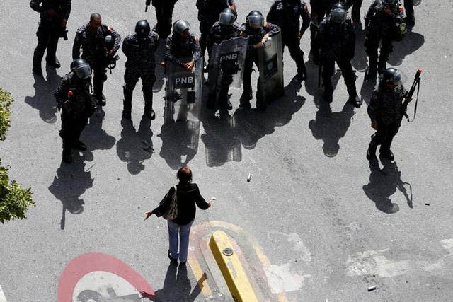 A woman argues with riot police in Caracas, Venezuela, on 4 August 2017