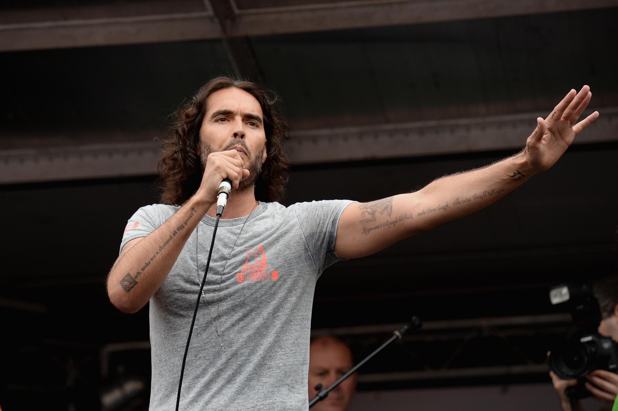 Comedian Russell Brand speaks to thousands of demonstrators gathered in Parliament Square to protest against austerity and spending cuts in 2015