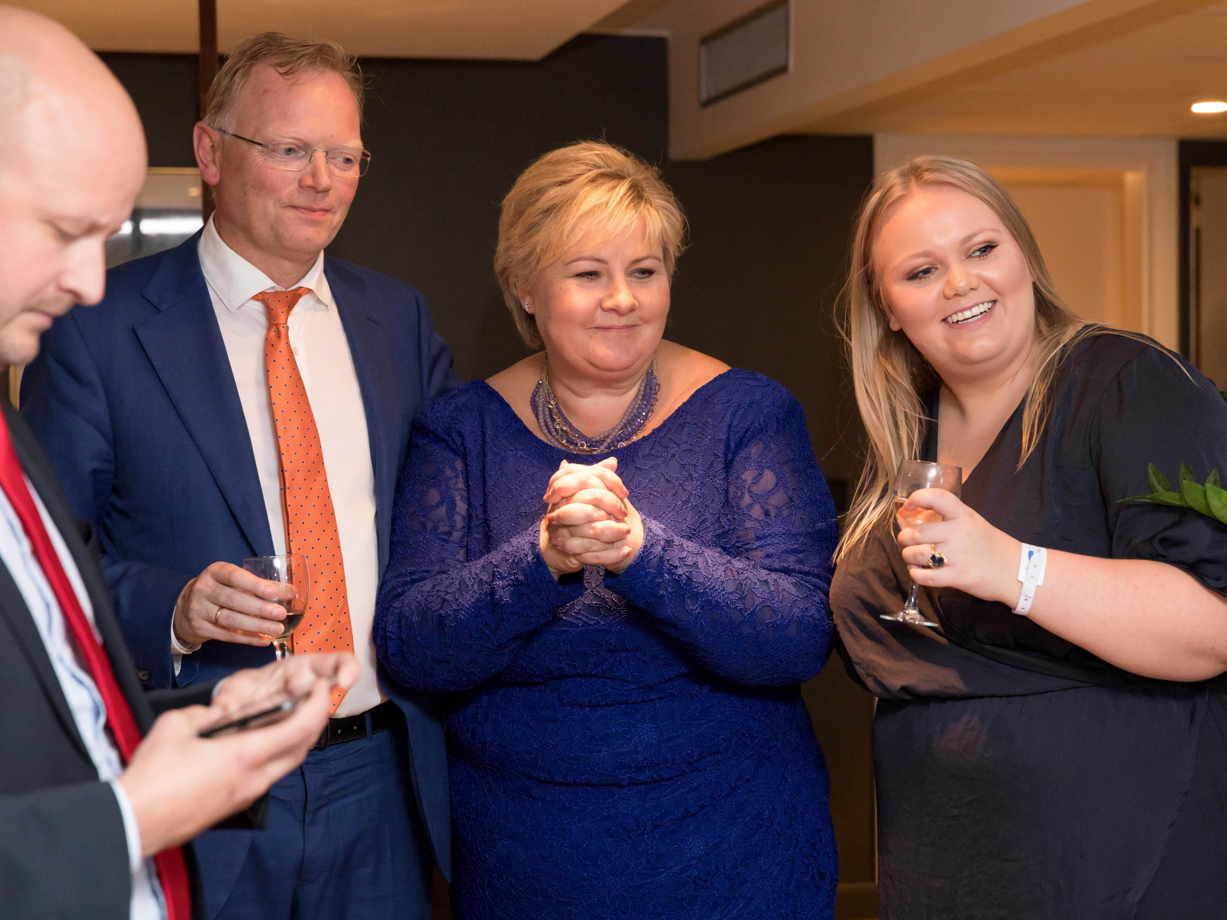 Norway's Prime Minister Erna Solberg, her daughter Ingrid Solberg Finnes and Sgbjorn Aanes, Solberg's adviser react to the good results for Solberg's Conservative Party in Oslo on 11 September 2017
