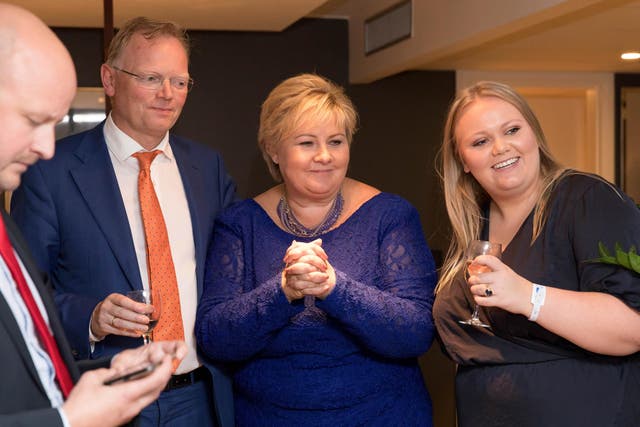 Norway's Prime Minister Erna Solberg, her daughter Ingrid Solberg Finnes and Sgbjorn Aanes, Solberg's adviser react to the good results for Solberg's Conservative Party in Oslo on 11 September 2017