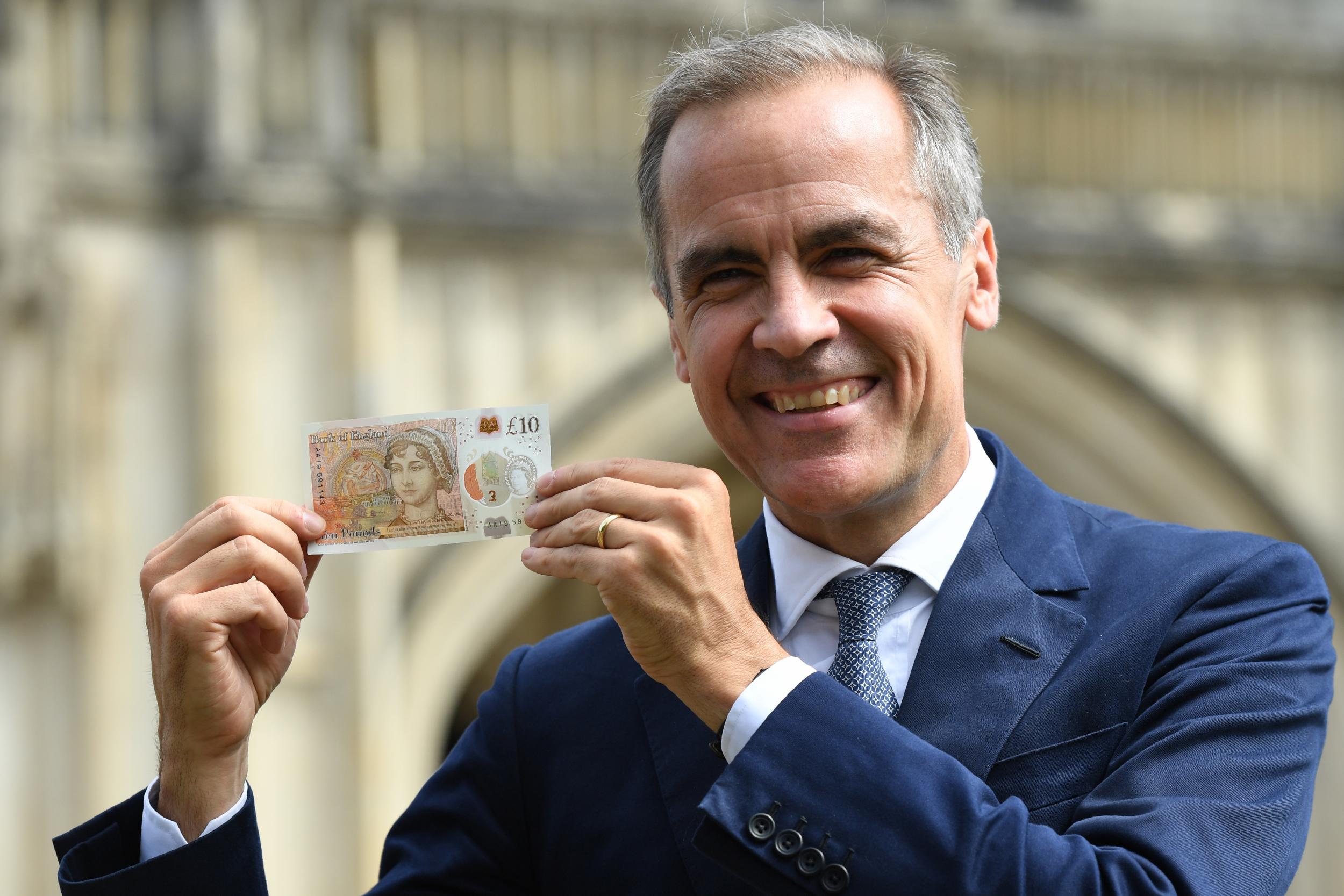 Governor of the Bank of England Mark Carney brandishing the new note