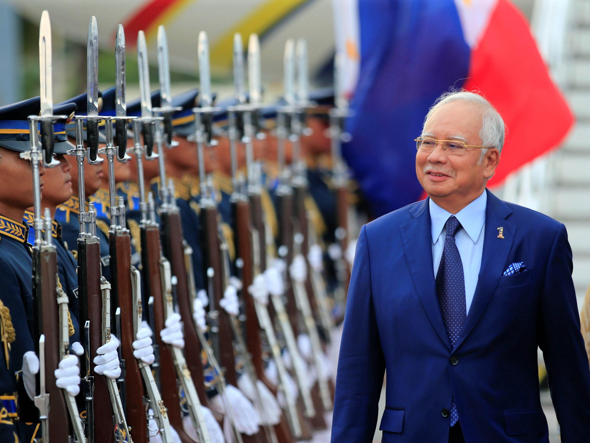 Malaysian PM Najib Razak reviews an honour guard