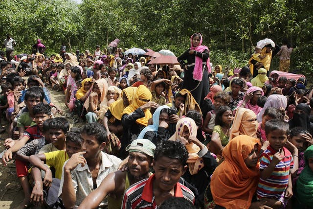 Rohingya Muslim refugees wait to receive relief goods during hot weather in Ukhiya, Cox's Bazar, Bangladesh
