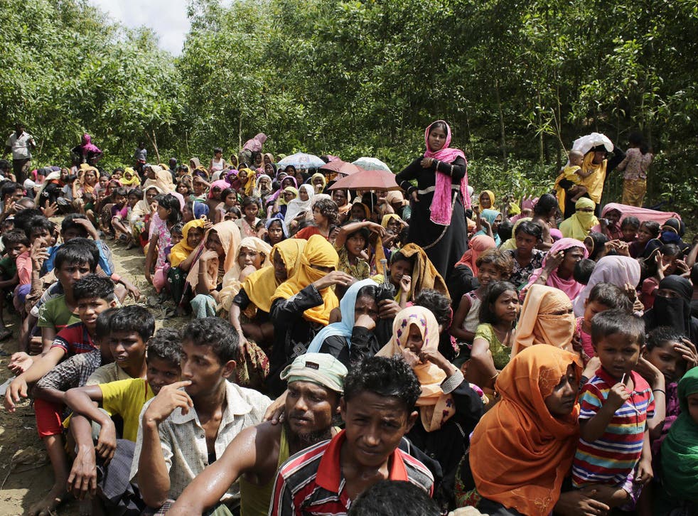 Rohingya Muslim refugees wait to receive relief goods during hot weather in Ukhiya, Cox's Bazar, Bangladesh