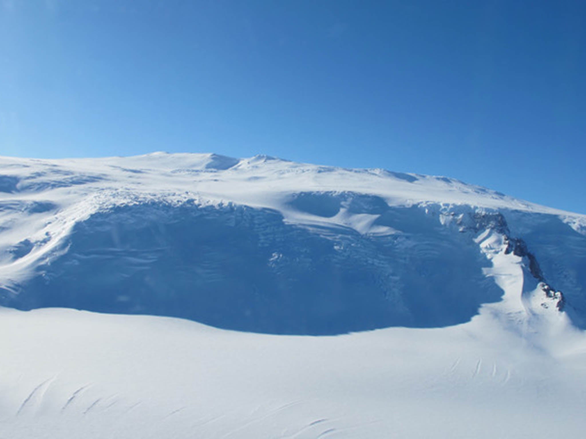 Mt Takahe grew over hundreds of thousands of years and its 8km wide caldera now towers above the ice sheet