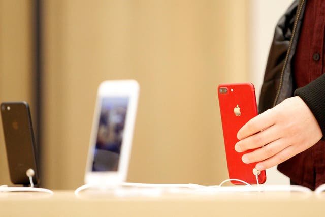 A person holds a red iPhone product at a Apple store in Nanjing, Jiangsu province, China, March 25, 2017. Picture taken March 25, 2017