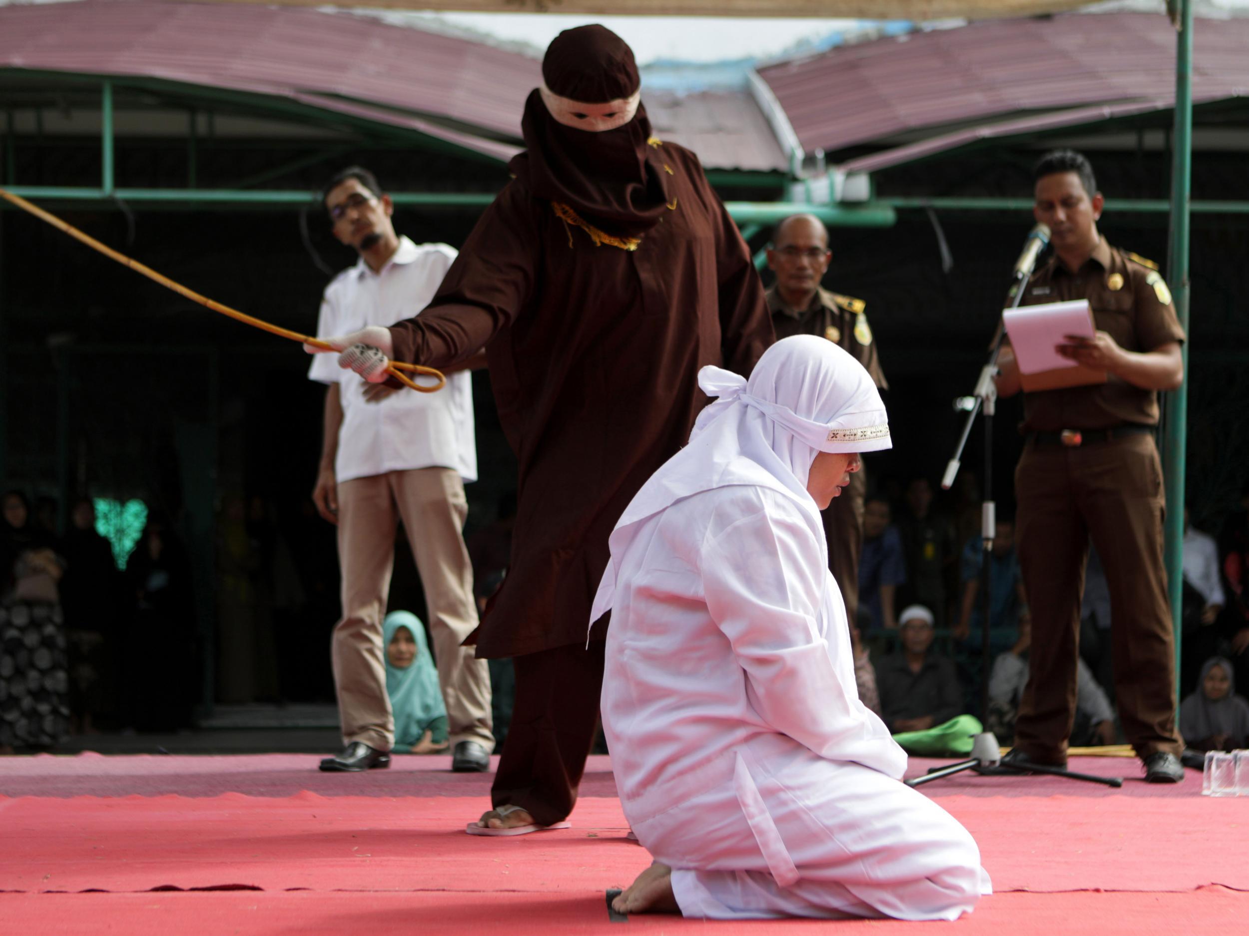 Indonesian woman is whipped in front of a crowd because she had