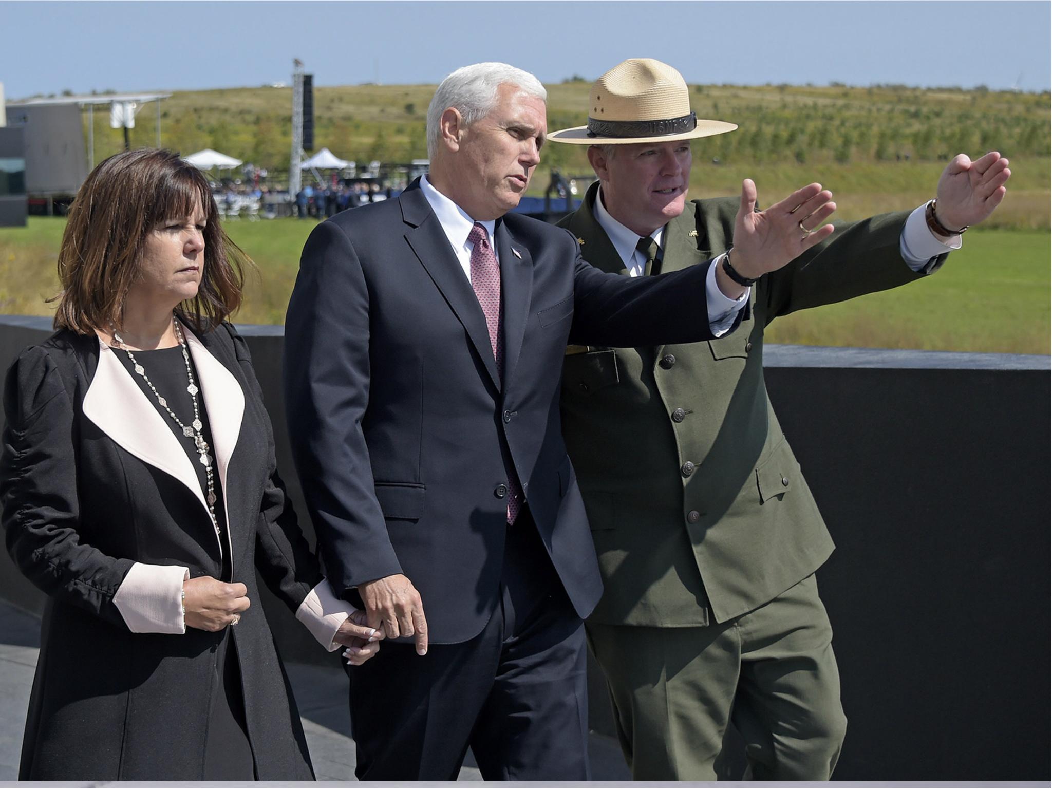 Stephen M. Clark, Superintendent of the Flight 93 Memorial, right, shows the flight path of United Flight 93 to Vice President Mike Pence and his wife Karen in Shanksville, Pennsylvania on 11 September 2017.