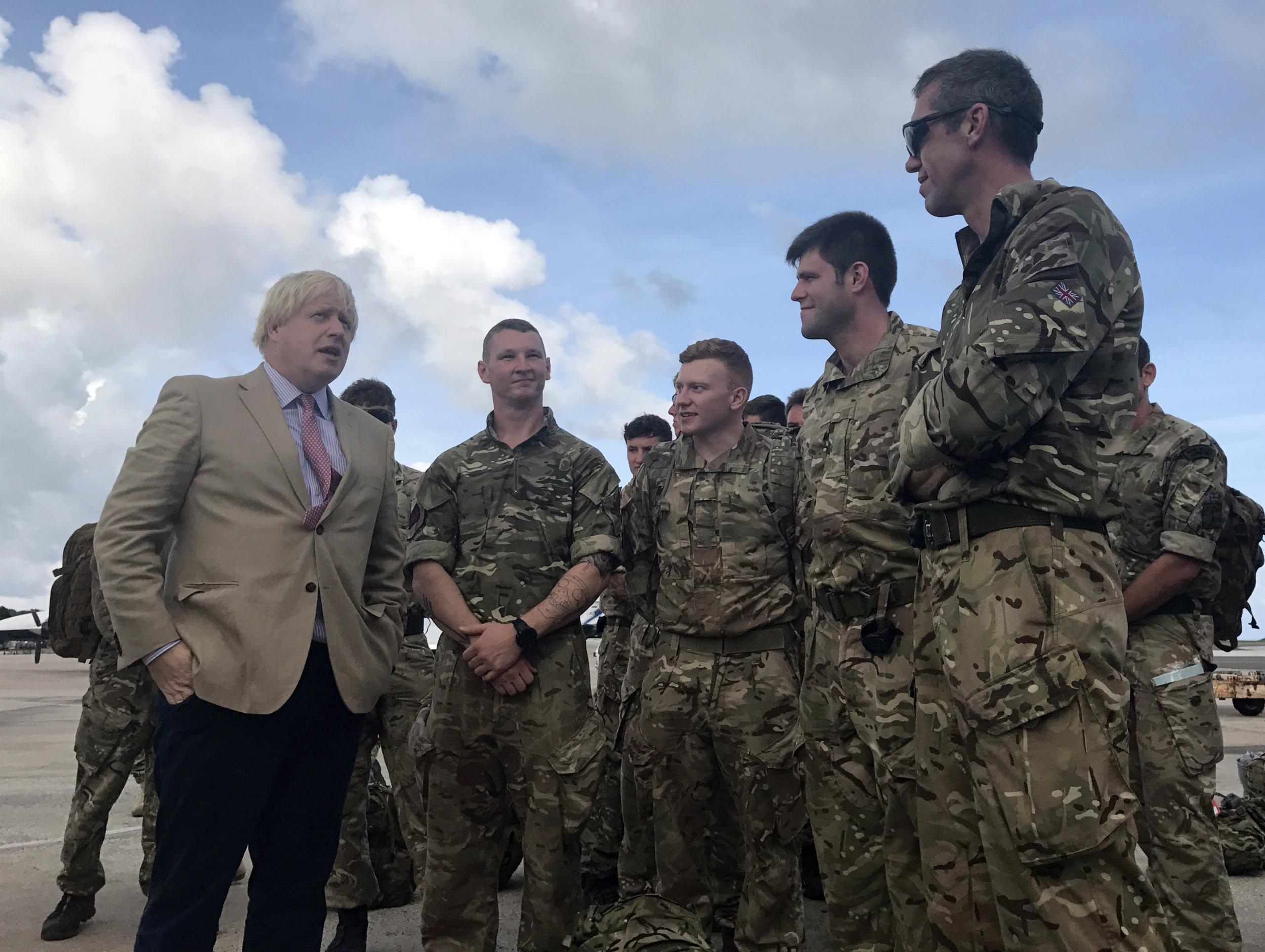 Foreign Secretary Boris Johnson talks to Royal Marines from 40 Commando in Barbados, where he stopped on his way to visit British territories ravaged by Hurricane Irma