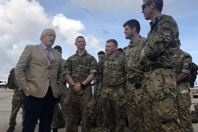 Foreign Secretary Boris Johnson talks to Royal Marines from 40 Commando in Barbados, where he stopped on his way to visit British territories ravaged by Hurricane Irma