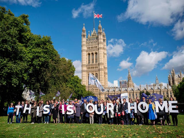 Demonstrators hold banners during a protest to lobby MPs to guarantee the rights of EU citizens living in the UK, after Brexit, outside the Houses of Parliament