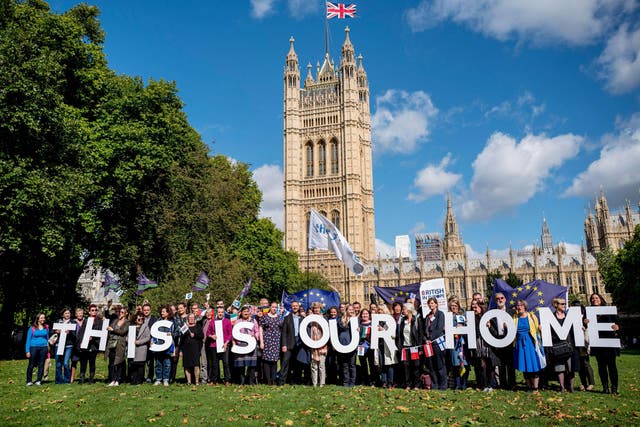 Demonstrators hold banners during a protest to lobby MPs to guarantee the rights of EU citizens living in the UK, after Brexit, outside the Houses of Parliament
