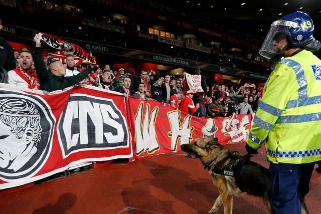 Police dogs guard fans at the away end at Emirates Stadium