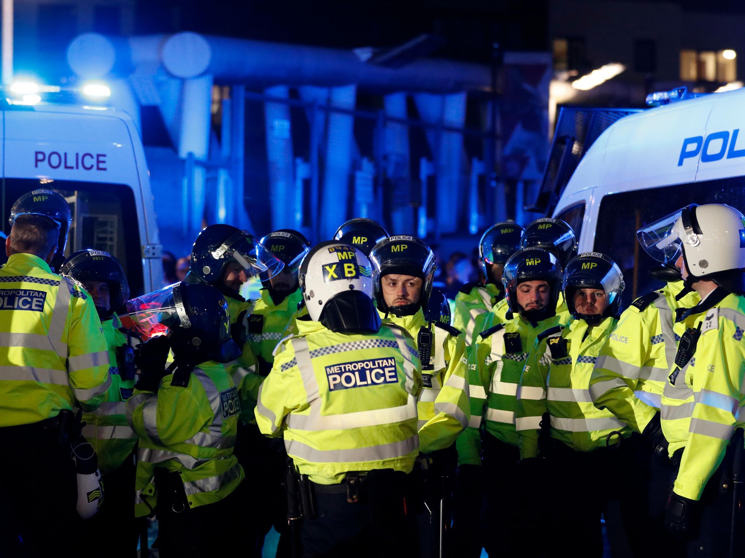 Riot police arrive outside the Emirates Stadium as kick off is delayed due to crowd safety issues