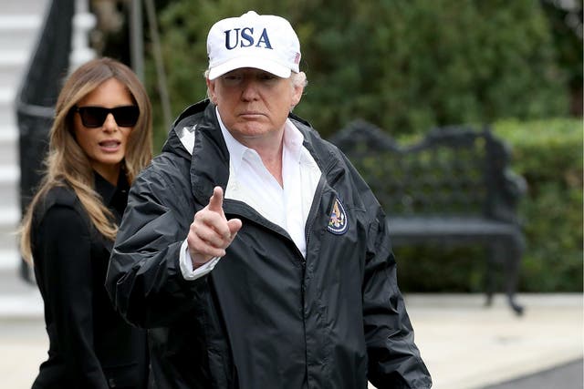 Donald Trump, with first lady Melania Trump, gestures as he answers questions while departing the White House for Florida on 14 September 2017