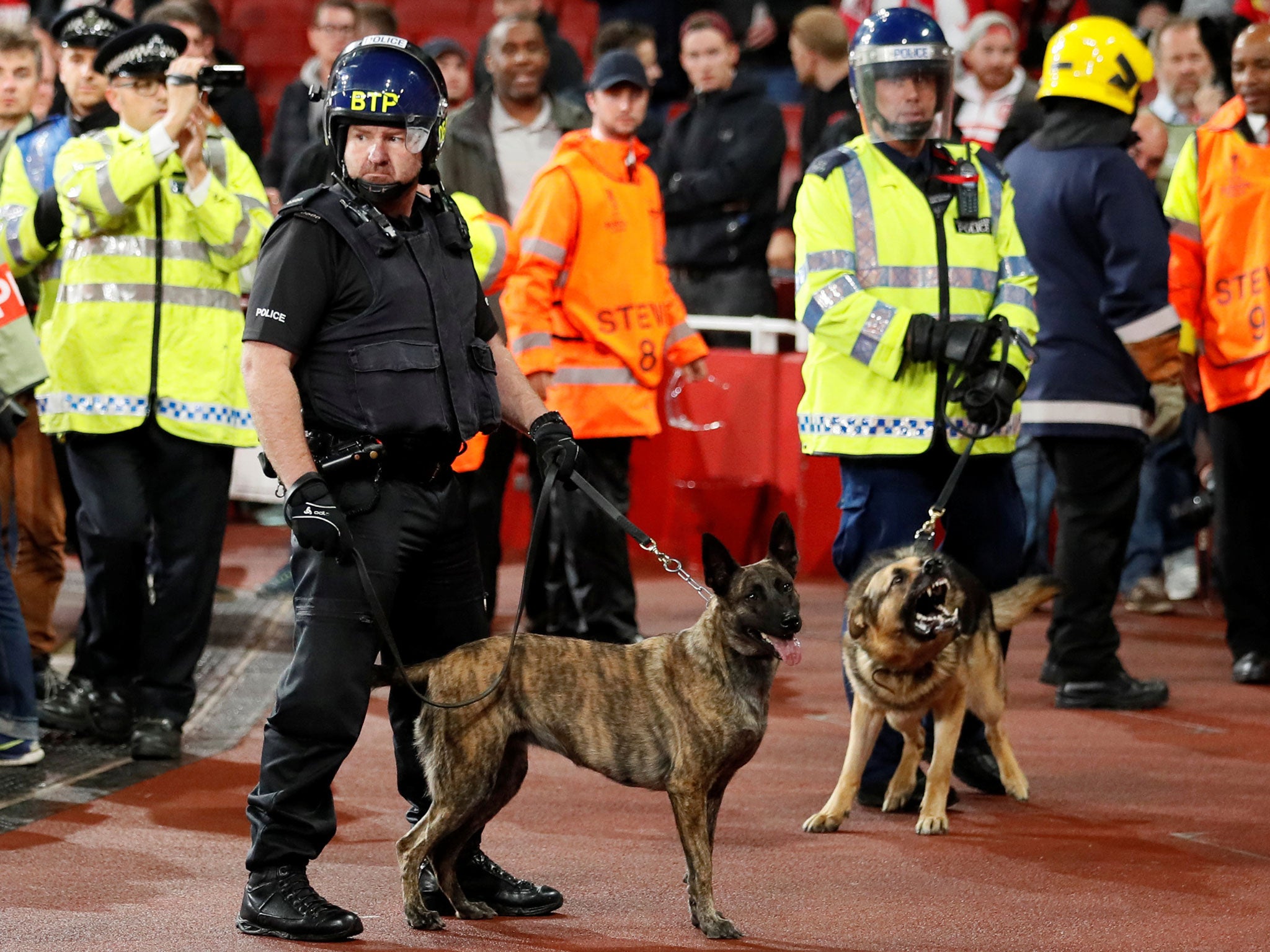 Police with dogs in front of Koln fans inside the Emirates stadium ahead of kick-off