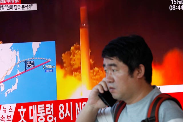 A television broadcasts a news report on North Korea firing a missile that flew over Japan's northern Hokkaido island