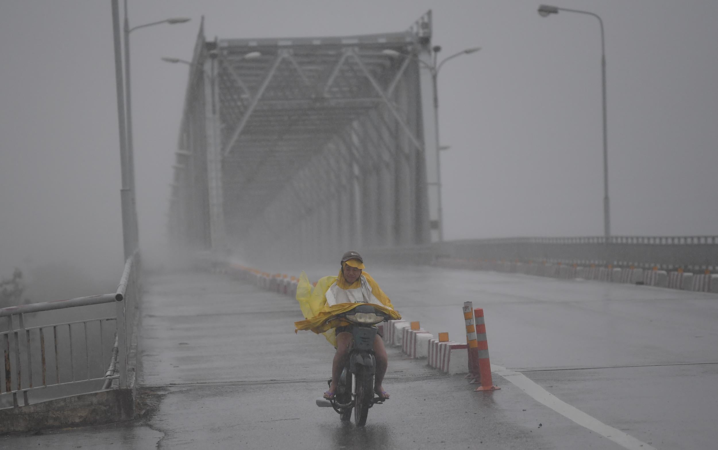 Heavy rain and wind lashed Vietnam's central coast Friday as Typhoon Doksuri made landfall, prompting mass evacuations