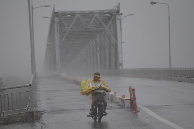 Heavy rain and wind lashed Vietnam's central coast Friday as Typhoon Doksuri made landfall, prompting mass evacuations