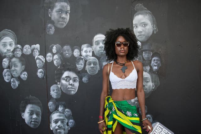 A woman with Afro hair pose at the Afropunk music festival in New York