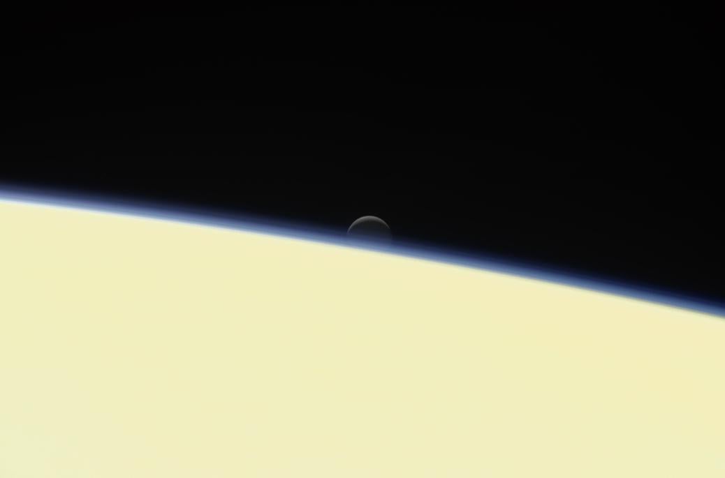 A farewell portrait sent back by Cassini, showing the intriguing moon Enceladus falling behind Saturn