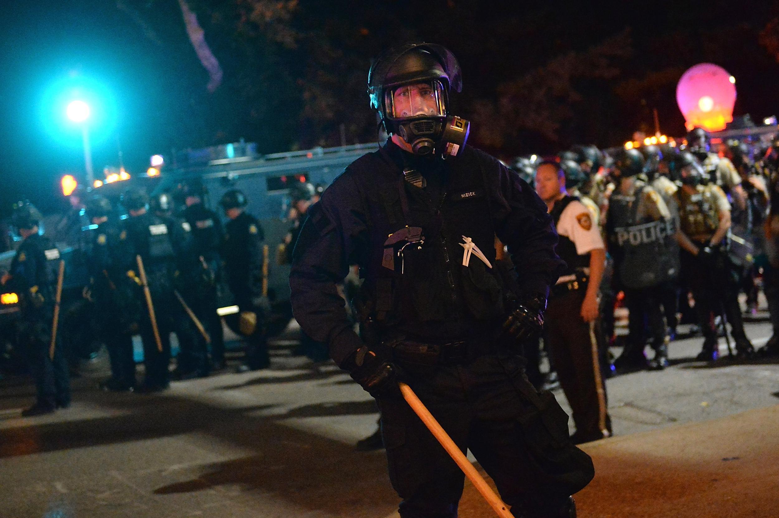 St Louis protests: Woman knocked over by police during demonstration charged with &apos;interfering&apos;