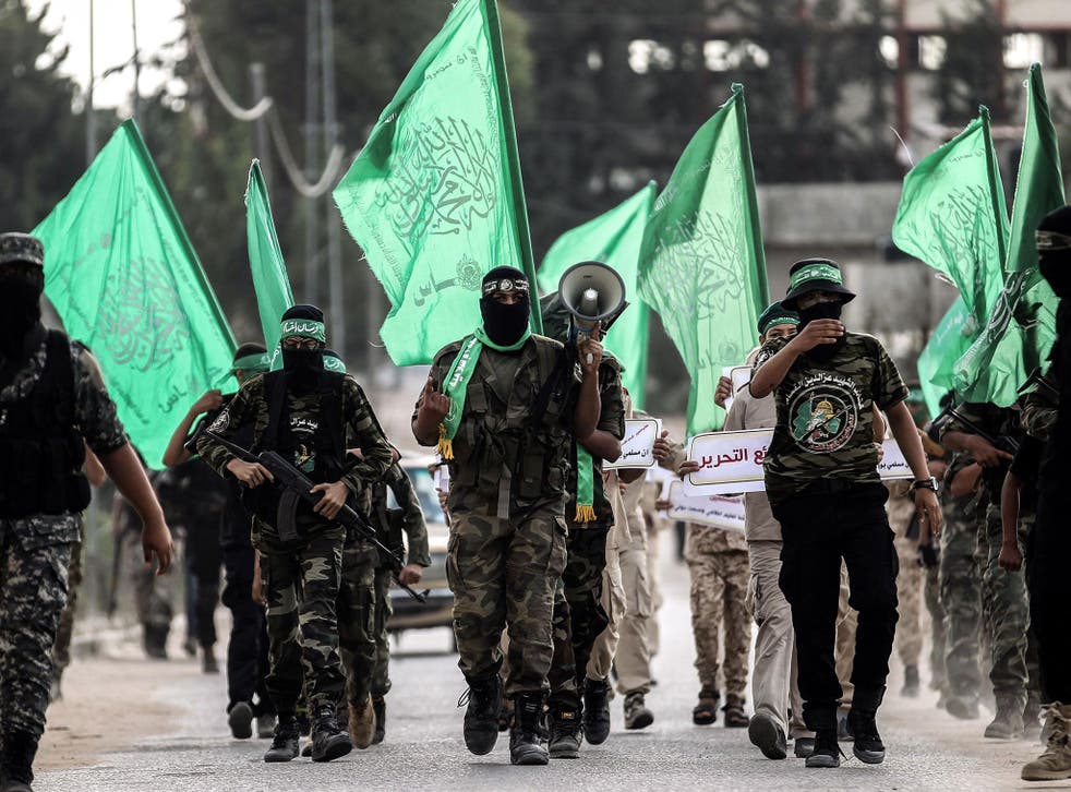 Masked youth cadets from the Ezzedine al-Qassam Brigades, the armed wing of the Palestinian Islamist Hamas movement, march in the southern Gaza Strip city of Khan Yunis