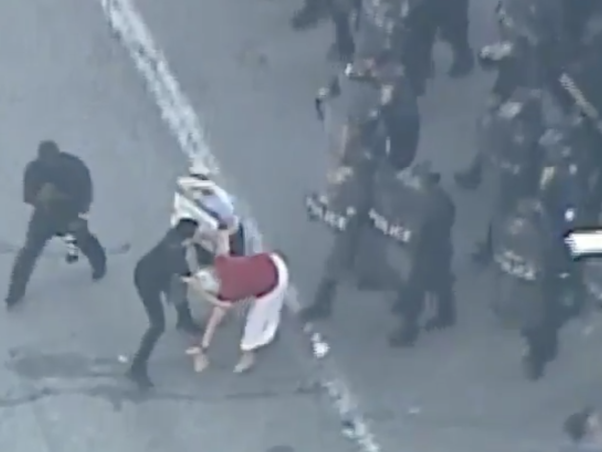 St Louis Metropolitan Police knock over a woman during protests in the Missouri city