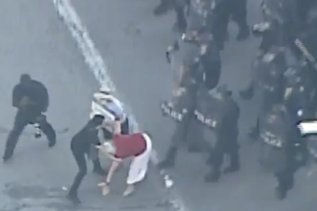St Louis Metropolitan Police knock over a woman during protests in the Missouri city