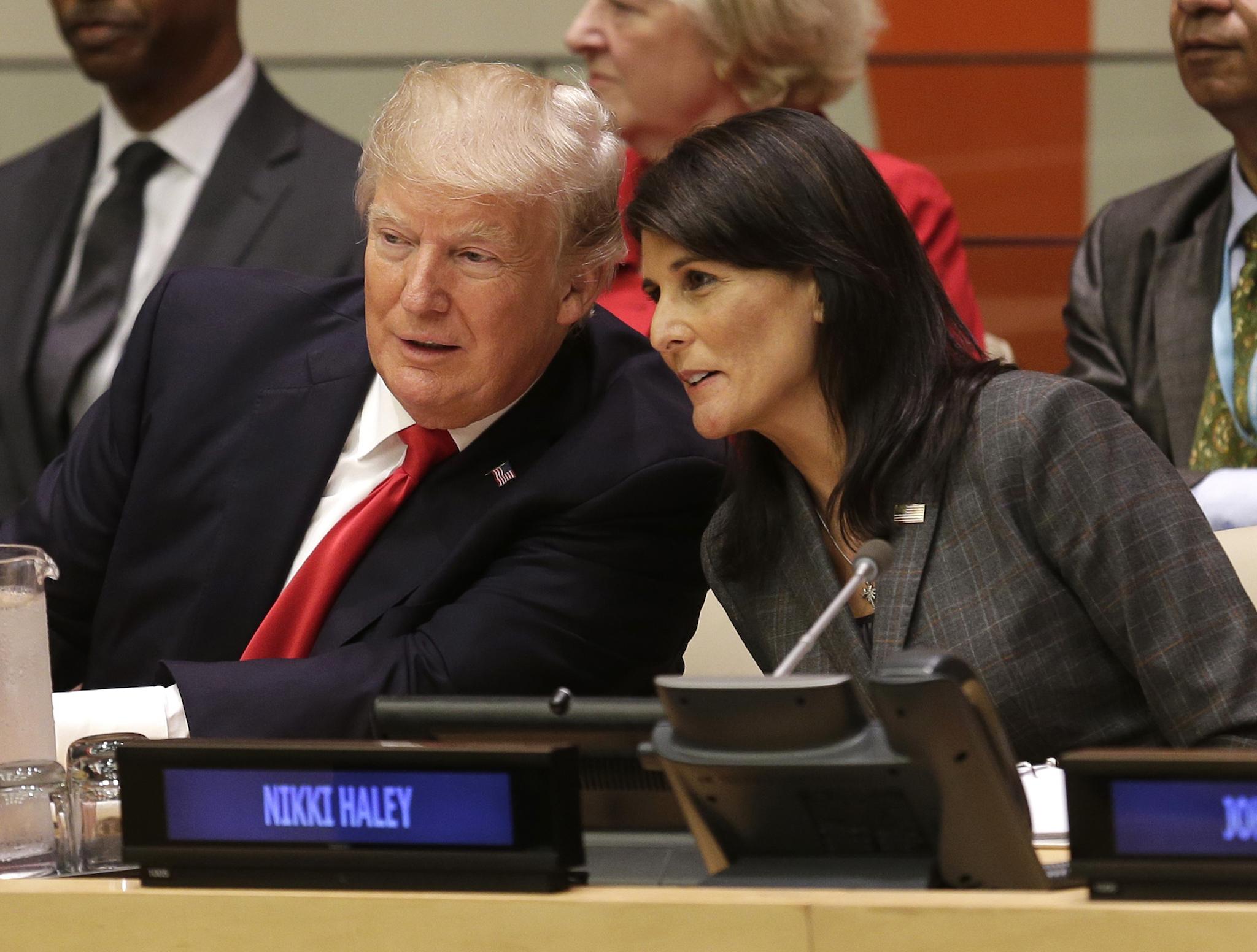 US President Donald Trump speaks with US Ambassador to the United Nations Nikki Haley