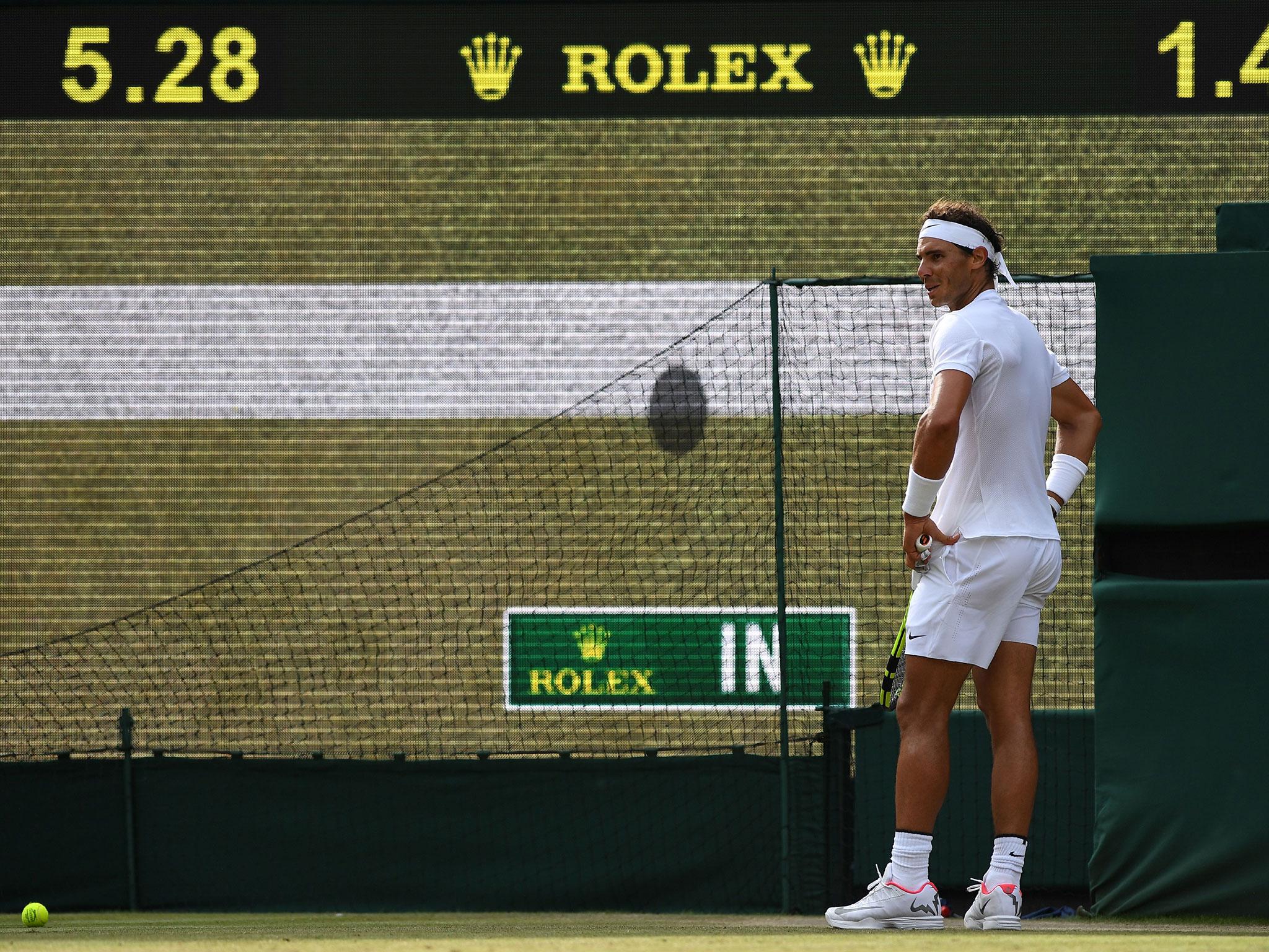 Rafael Nadal reacts after a Hawk-Eye decision goes against him at Wimbledon