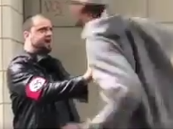 A man wearing a swastika armband was caught on video being punched in downtown Seattle