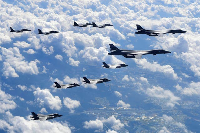 US Air Force B-1B Lancer (R), US F-35B stealth jet fighters (bottom) and South Korean F-15K fighter jets (top) flying over South Korea during a joint military drill