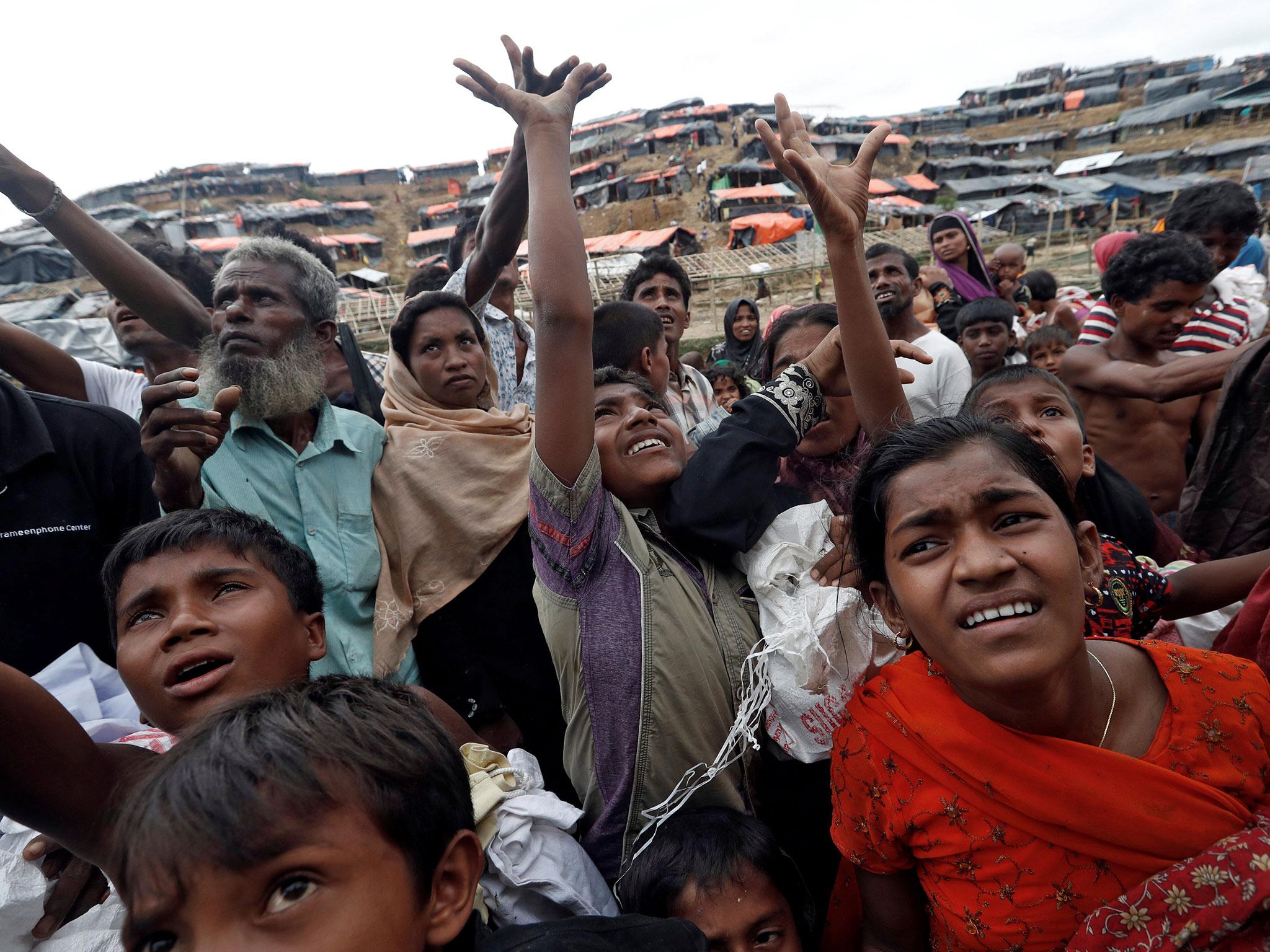 Aid is distributed to Rohingya refugees after their arrival at Coxs Bazar, Bangladesh